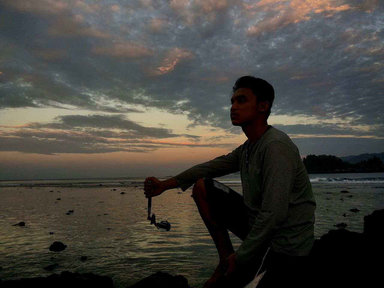 lifestyles, sky, young adult, leisure activity, water, standing, casual clothing, person, three quarter length, cloud - sky, young men, sea, waist up, side view, sunset, looking at camera, sunglasses