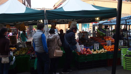 People at market stall in city