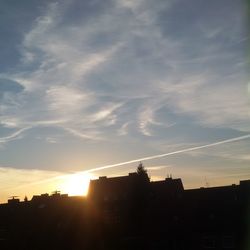 Low angle view of silhouette buildings against sky during sunset