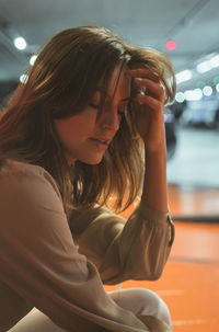 Portrait of young woman sitting outdoors