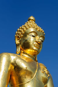 Low angle view of statue against blue sky