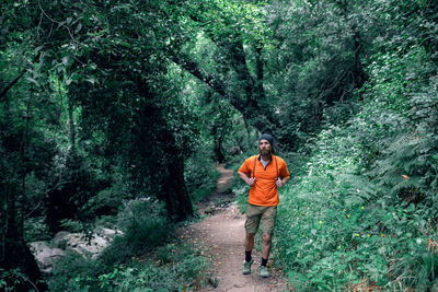 Full length of a man standing in forest