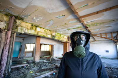 Portrait of woman standing in abandoned building