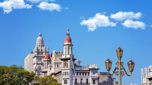 Low angle view of buildings against blue sky