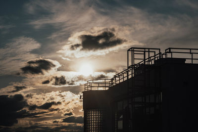 Low angle view of silhouette buildings against sky during sunset