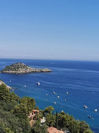 High angle view of sea against clear blue sky