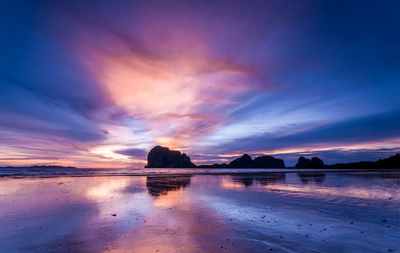 Scenic view of sea against romantic sky at sunset