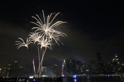 Low angle view of firework display at night