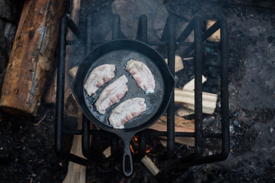 High angle view of meat on barbecue grill