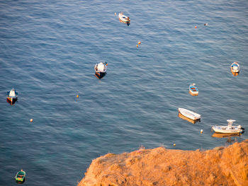 High angle view of birds flying over sea