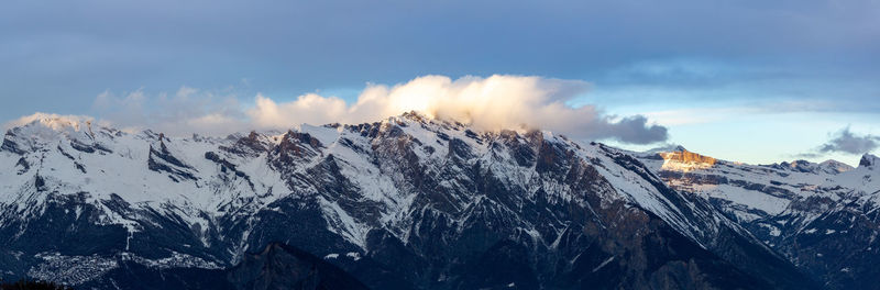 Panoramic view of snowcapped mountains against sky