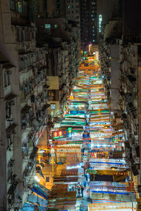 High angle view of illuminated night market amidst buildings in city