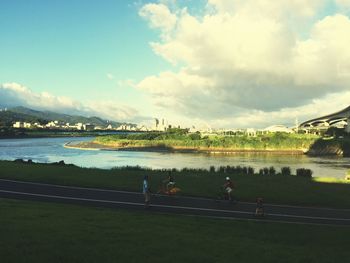 Scenic view of river against cloudy sky