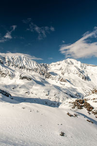 Scenic view of snow covered mountains against sky