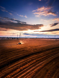 Scenic view of field against sky during sunset