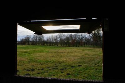 Scenic view of field seen through window