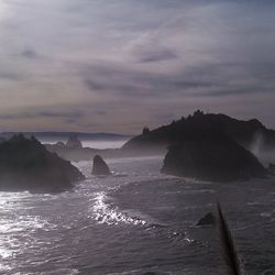 Scenic view of sea against cloudy sky