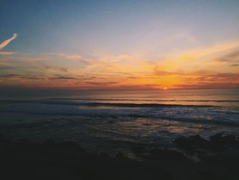 View of sea against cloudy sky during sunset