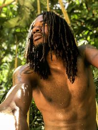 Close-up of shirtless caribbean man looking at camera