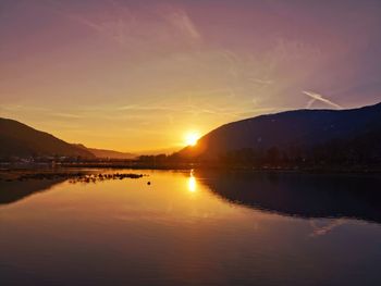 Scenic view of lake against sky during sunset