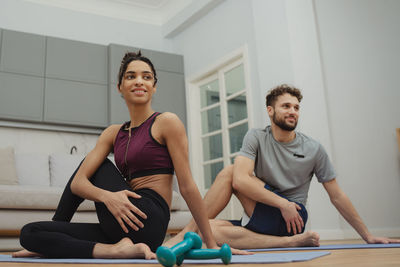 Portrait of young woman exercising in gym