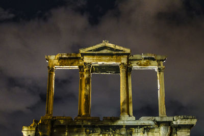 Old temple against cloudy sky at night