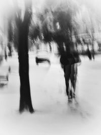 Blurred motion of people walking on road in winter