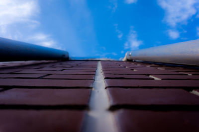 Surface level of road against blue sky