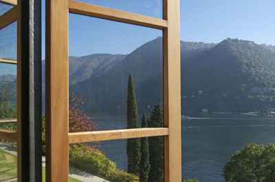 Scenic view of lake by mountains against sky