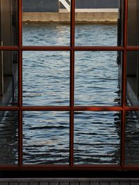 Close-up of sea seen through window