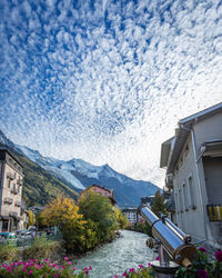 Scenic view of buildings and mountains against sky