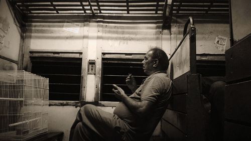 Side view of man sitting in train