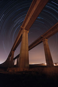 Train bridge star trails in the background