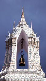 Low angle view of statue against temple against clear sky