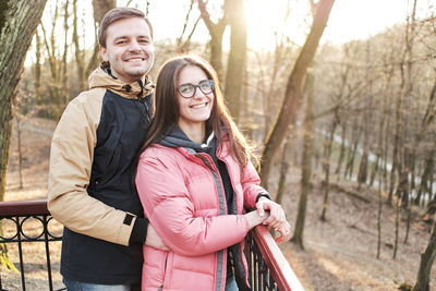 Young loving couple enjoy the sun and warm stroll in the spring park