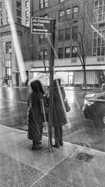 Rear view of people walking on road