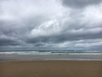 Scenic view of sea against cloudy sky