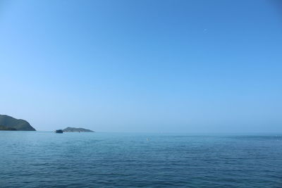 Scenic view of sea against clear blue sky