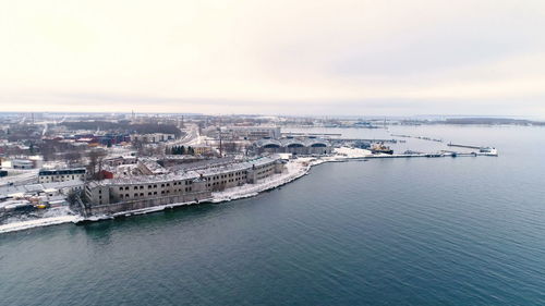 High angle view of buildings by sea against sky