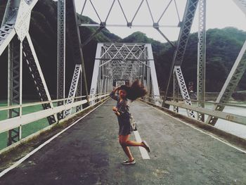 Woman standing on bridge