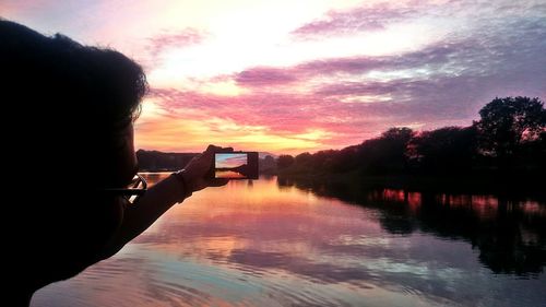 Scenic view of river at sunset