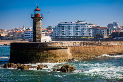 View of the city of porto and the historical felgueiras lighthouse  located at douro river mouth