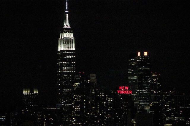 LOW ANGLE VIEW OF ILLUMINATED SKYSCRAPERS AGAINST SKY