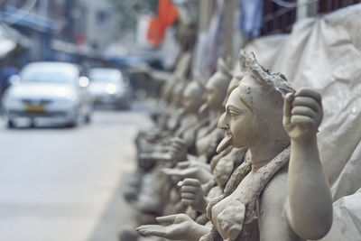 Close-up of buddha statue in city