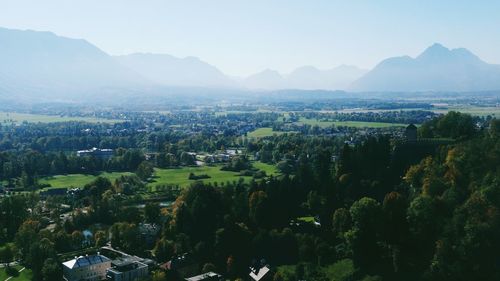 Aerial view of landscape and mountains against clear sky