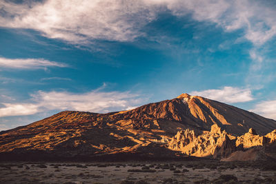 Scenic view of volcanic mountain against sky