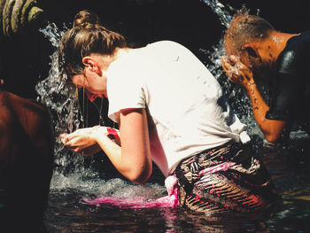 Young woman swimming in water