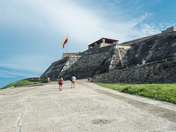 People on mountain road against sky