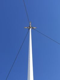 Low angle view of cables against clear blue sky