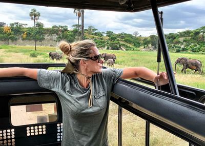 Woman in safari vehicle at national park